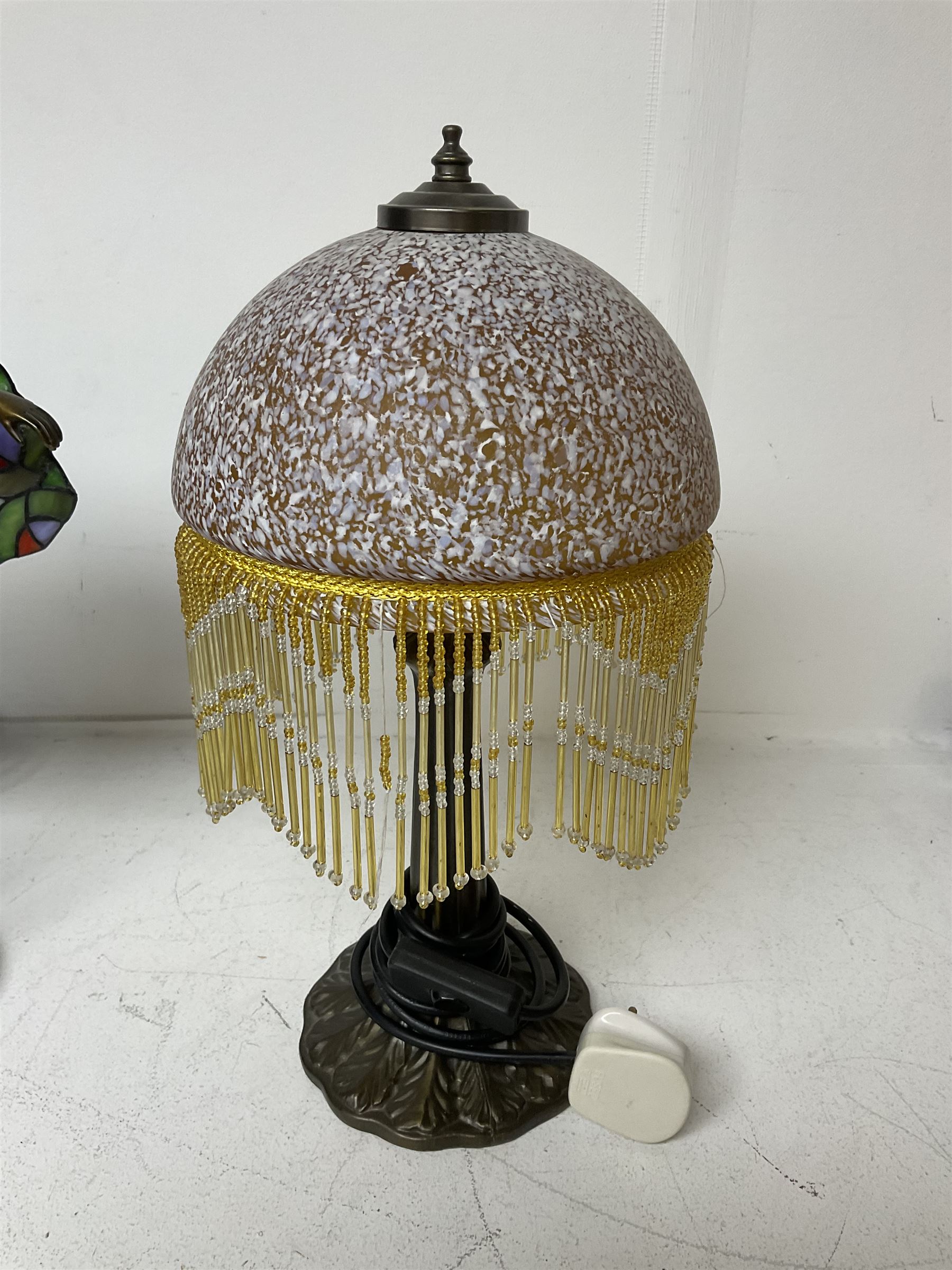 Art Deco Tiffany style table lamp, modelled as a dancer with a fan shaped shade, together with another table lamp with mottled glass and tassel shade, tallest H41cm