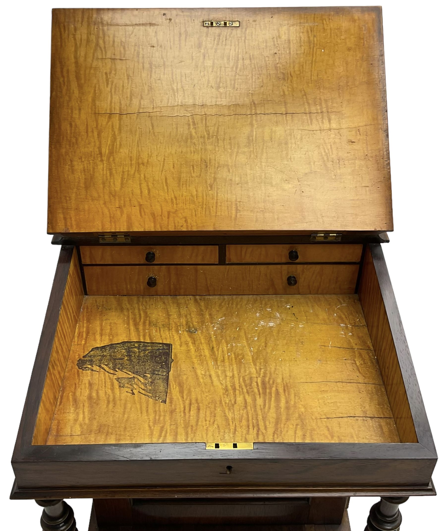 Victorian walnut Davenport, hinged sloping top with inset leather writing surface, enclosing satinwood lined interior with two drawers over faux drawer, fitted with inkwell drawer and pen compartment to the side over four drawers with an opposing false set, raised on spiral turned supports united by a shaped platform base