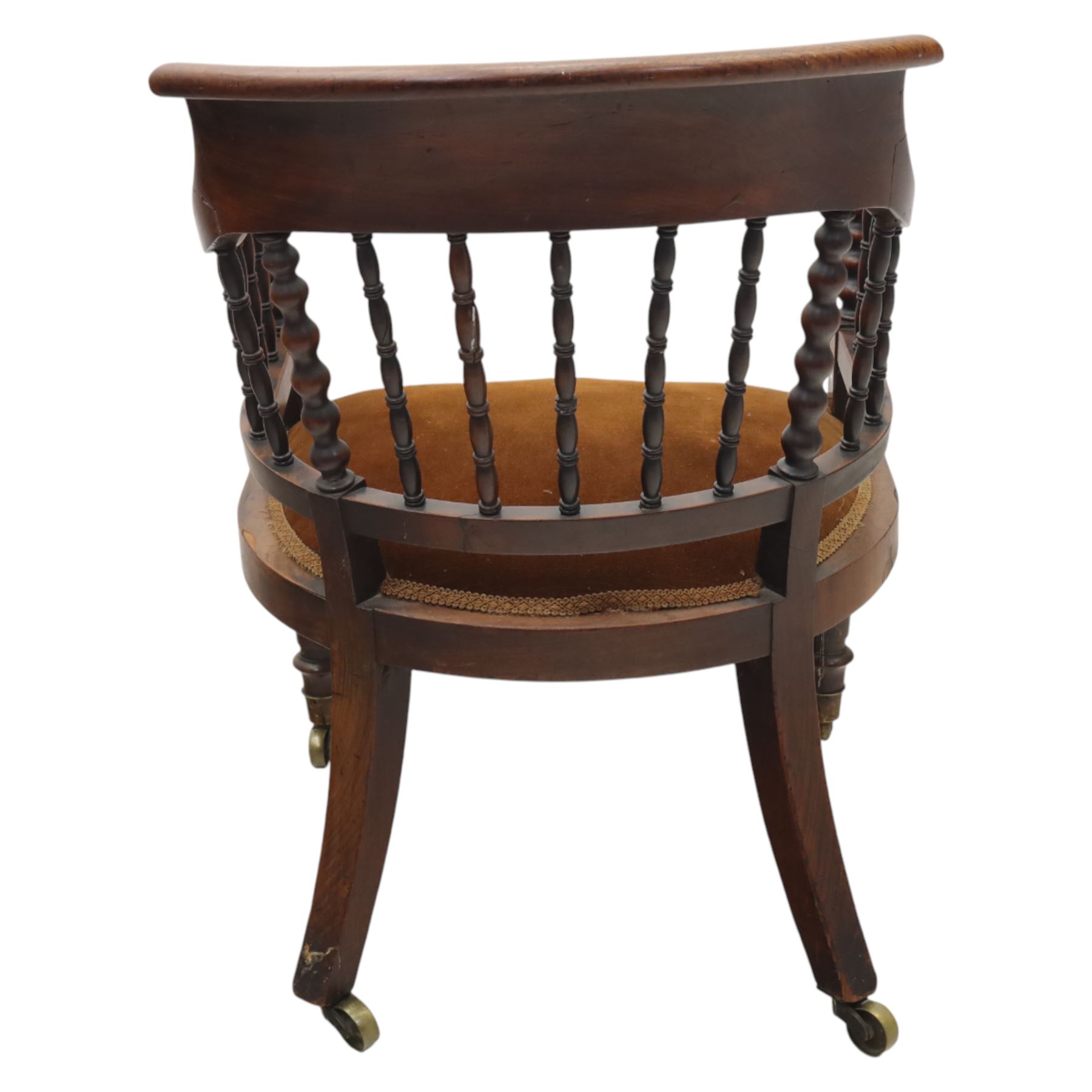 Late 19th-century captain's chair,  with spindle and bobbin turned shaped back, with brown velvet upholstered seat, raised on turned legs with brass castors, old damage and repairs 