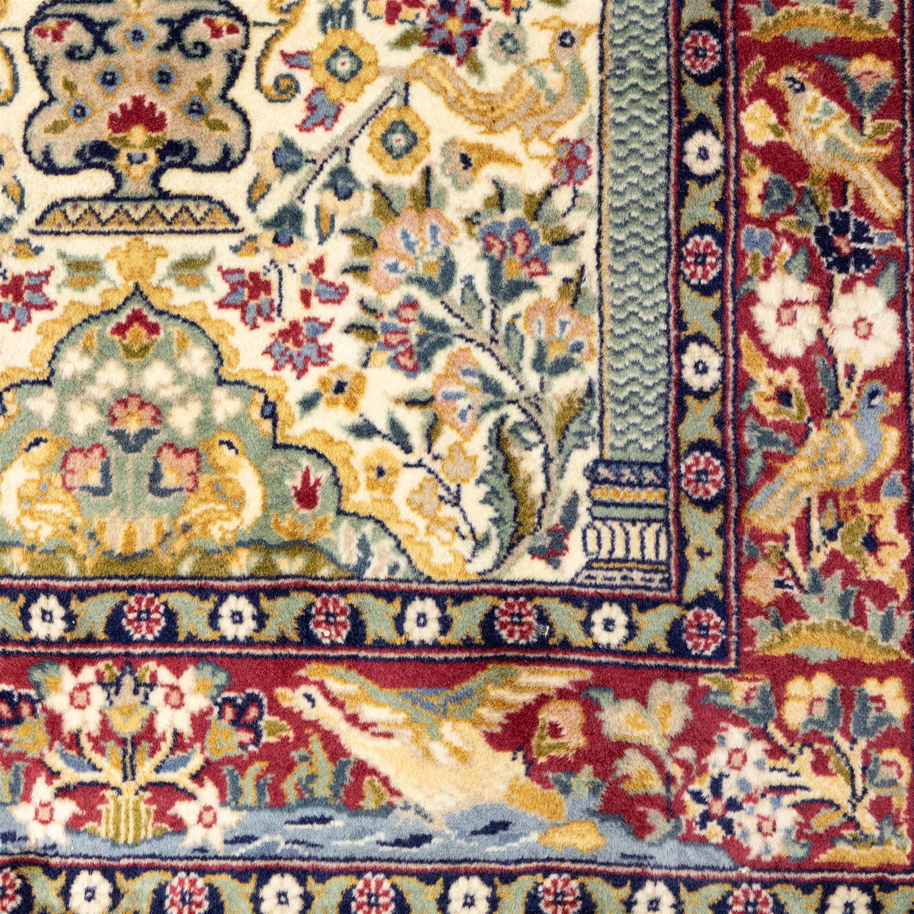Two Central Persian rugs, ivory ground with a symmetrical foliate and floral design around a shaped cartouche medallion with a red floral and bird motif border with contrasting guard stripes, 142x76cm, Central Persian Kashan rug, crimson central field with a floral and foliate design with a stylized rosette medallion incorporating palmettes and scrolling vine work, enclosed by a dark navy border and multiple guard stripes, 117x68cm, (2)