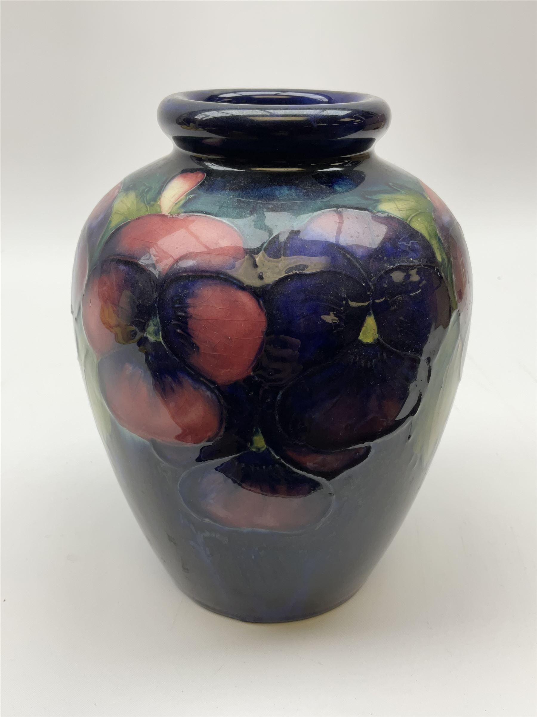Moorcroft vase of ovoid form, decorated in Pansy pattern upon a dark