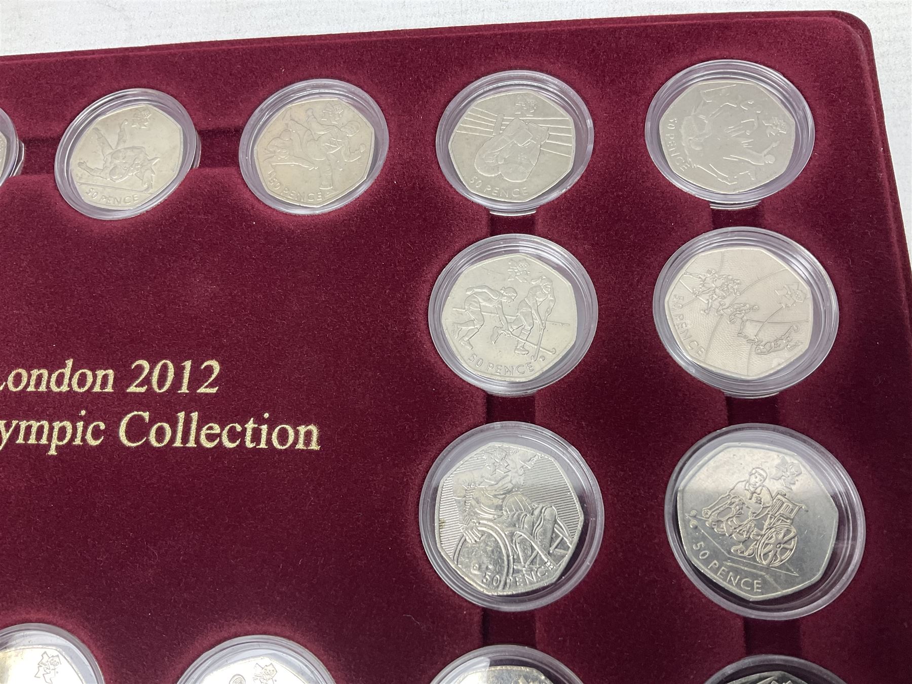 Queen Elizabeth II United Kingdom London 2012 Olympic commemorative fifty pence collection comprising twenty-nine coins, housed in unofficial display case