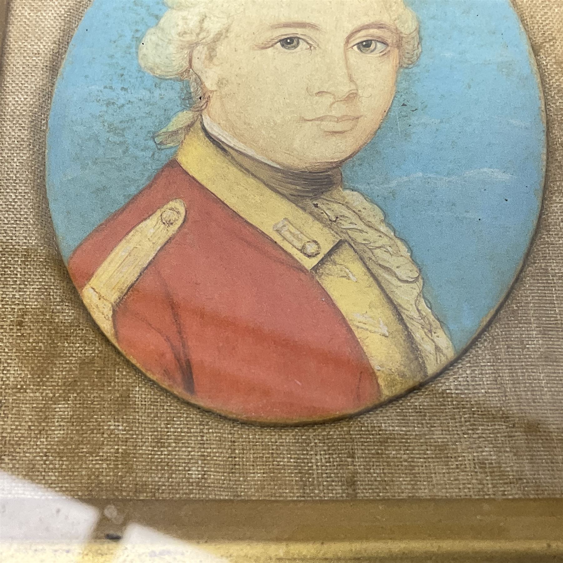 19th century watercolour head and shoulder portrait miniature of a Georgian  British Army Officer, oval 6.5 x 5cm, oak frame; and tapestry silhouette portrait miniature of a British soldier, 10.5 x 7cm, Hogarth frame (2)