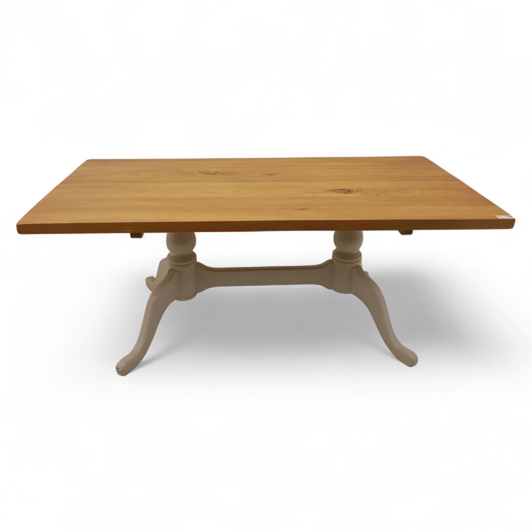 Contemporary light oak dining table, painted tripod bases with stretcher 
