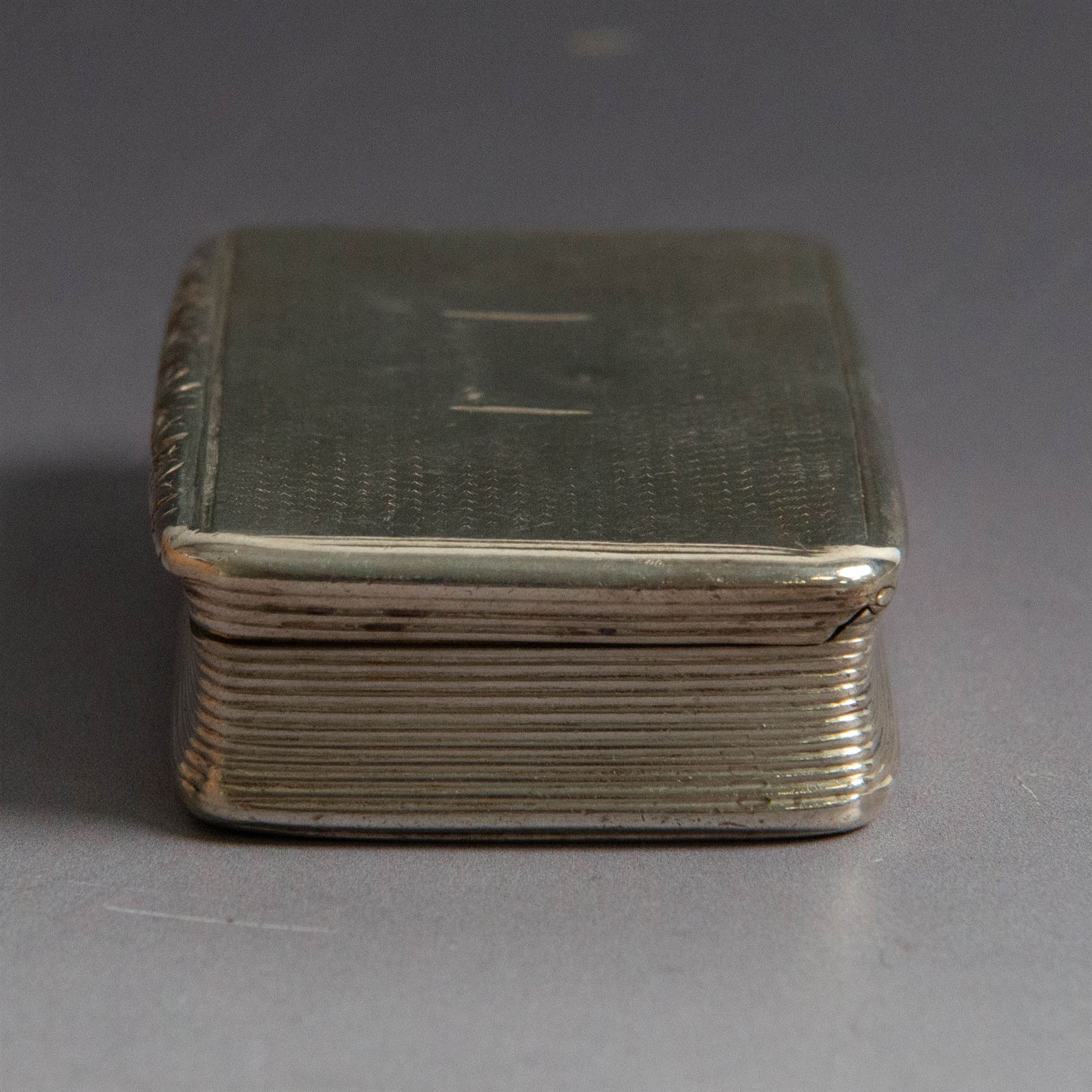 William IV silver snuff box, of rectangular form with rounded corners and embossed lip, the hinged cover with engine turned decoration and vacant cartouche, hallmarked Joseph Willmore, Birmingham 1830, H2cm, W7cm