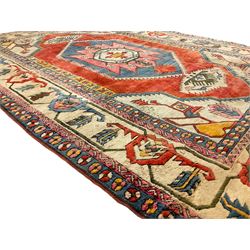 Anatolian Turkish ivory ground carpet, the central geometric pole medallion within an amber field, the guarded border decorated with stylised plant motifs surrounded by bands of repeating flower heads