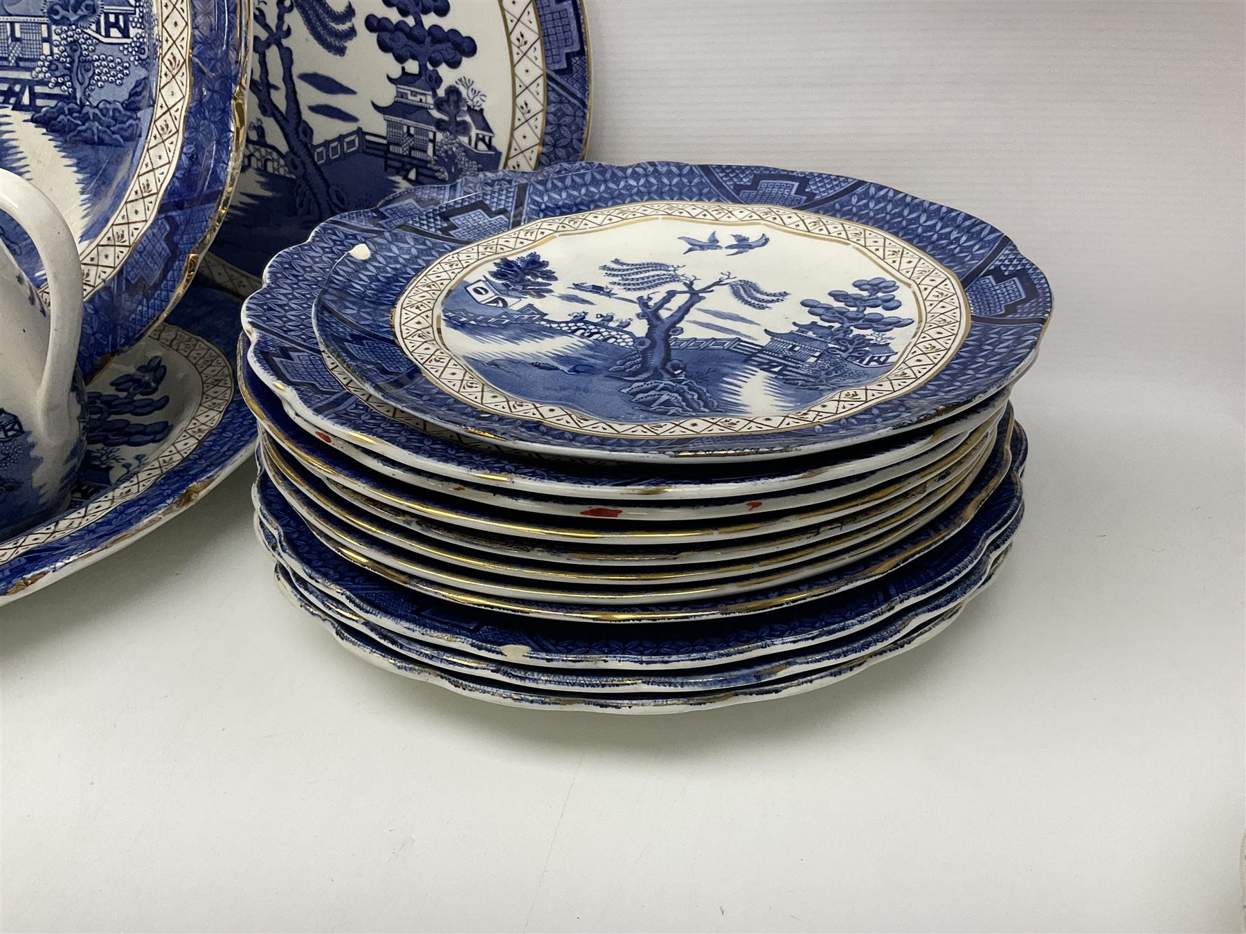 Booths Real Old Willow pattern part tea and dinner service, to include two meat platters, cake stand, teapot, two jugs, sugar bowl, sauce boat, teacups and saucers and a collection of plates and bowls