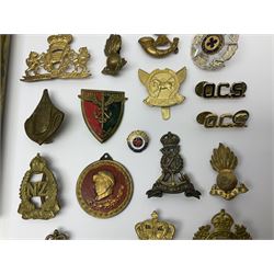 Collection of approximately sixty worldwide medals, metal badges, belt buckles, cloth badges, trench art, brass button stick etc