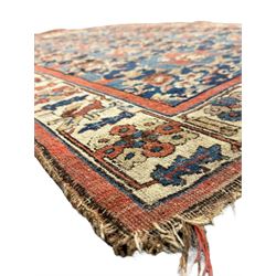 Persian Bidjar indigo ground rug, the busy field decorated with large floral motifs, the guarded ivory border adorned with repeating flower heads and stylised leaves
