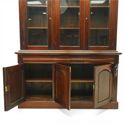 Victorian revival hardwood dresser, projecting moulded cornice above three glazed doors enclosing shelves, moulded top over three drawers and three panelled cupboard doors, flanked by applied carved scroll brackets, on plinth base,