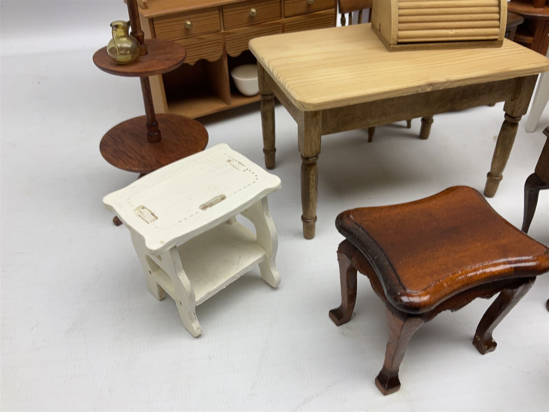 Doll's house wooden furniture - over twenty items including good quality pine Welsh dresser by Tony of Lincoln; tall 'glazed' bookcase; two-tier side cabinet; grand piano; bedside chest, mule chest, Canterbury; cradle; Georgian style hanging corner cupboard; dumb waiter; tables; chairs; rocking chair etc; various scales