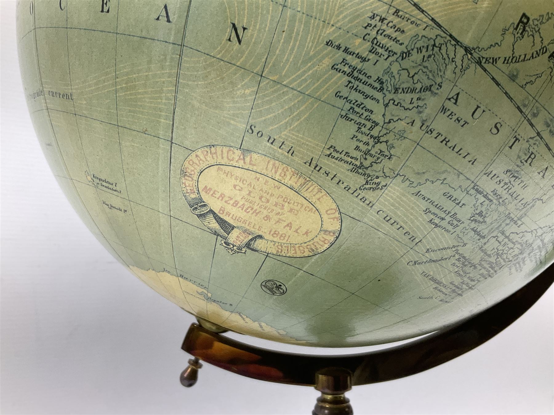 Terrestrial globe by Grinell, Washington, mounted on a brass half meridian and raised on turned wood pedestal base, H55cm