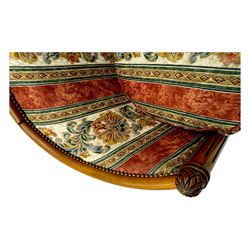 Pair of cherry wood framed tub-shaped armchairs, upholstered in striped floral fabric with brass stud trim, carved walnut frame with fluted supports capped with pinecone finials, on turned feet