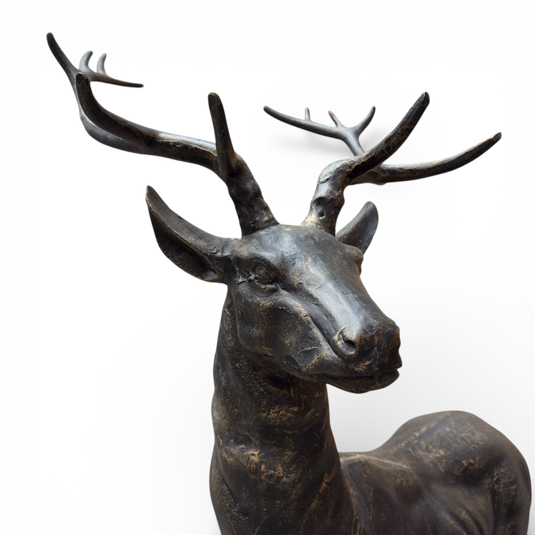 Pair of life-size cast iron garden or home stags, modelled standing upon oval plinths