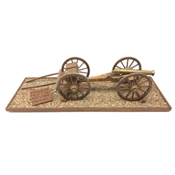  Wooden and brass scale model of an c1815 Napoleonic Field Gun with Limber, brass barrel with ammunition boxes on metal bound wooden spoked wheels, on rectangular gravel base, L74.5cm D26cm, H18cm  
