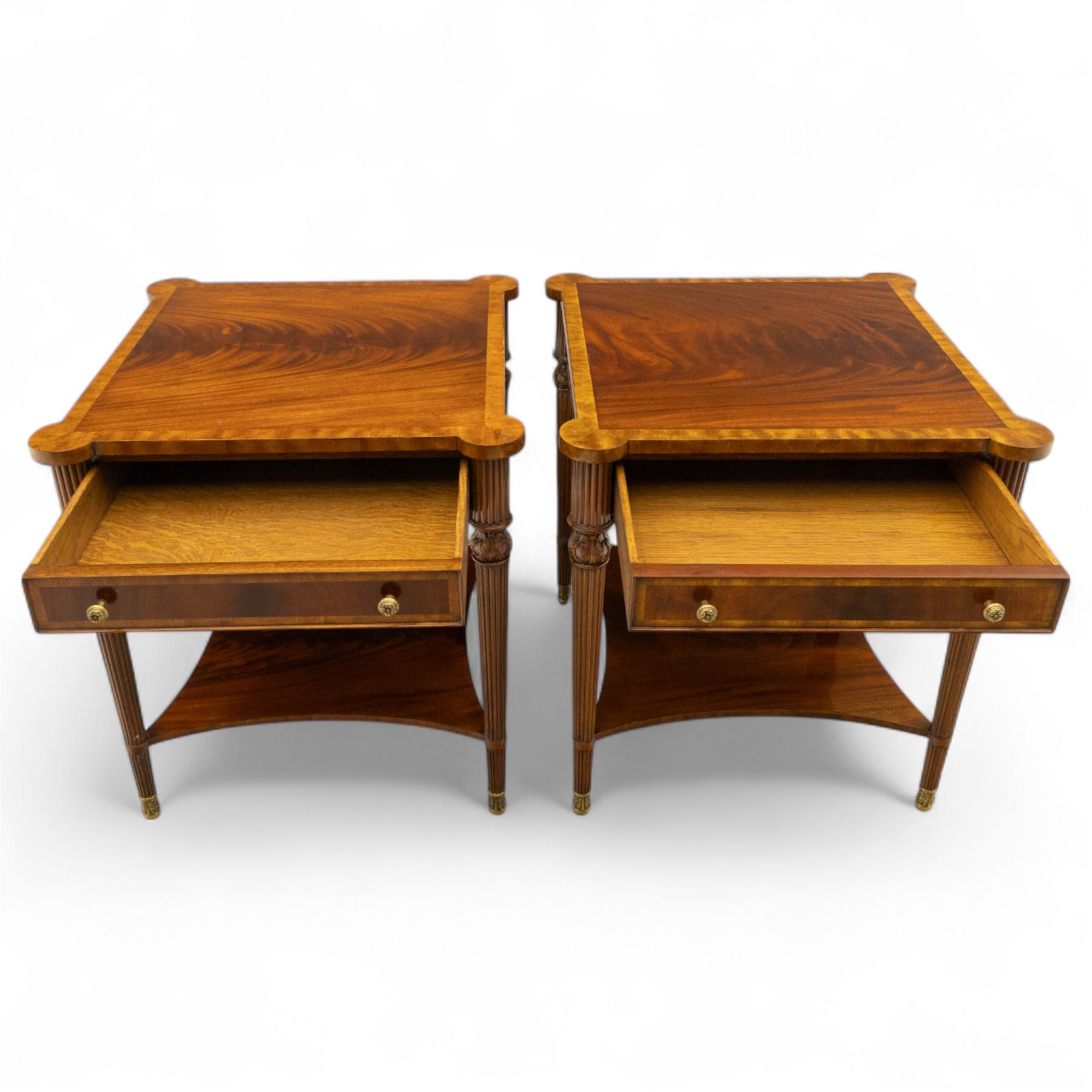 Maitland Smith - Pair of mahogany side tables, the rectangular top with rounded corners, the top edge inlaid with movingui wood, above two under-tier shelves, and frieze drawer, supported on stop-reed and acanthus foliate carved legs united by platform stretcher, raised on brass sabot foot caps