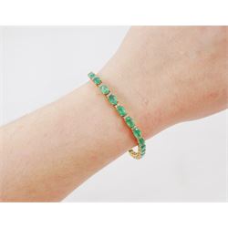 18ct gold emerald and diamond bracelet, twenty-seven oval cut emeralds, each spaced by two round brilliant cut diamonds, stamped 18K, total emerald weight approx 12.35 carat, total diamond weight approx 0.50 carat