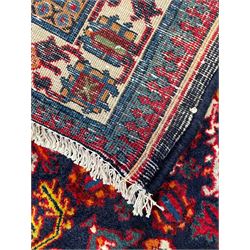 Persian Meimeh indigo ground rug, the central medallion within a field of small floral lozenge motifs, the guarded border with repeating pattern