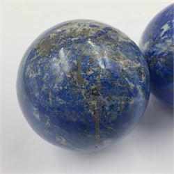 Pair of Lapis lazuli spheres, upon a carved stone stands, D8cm