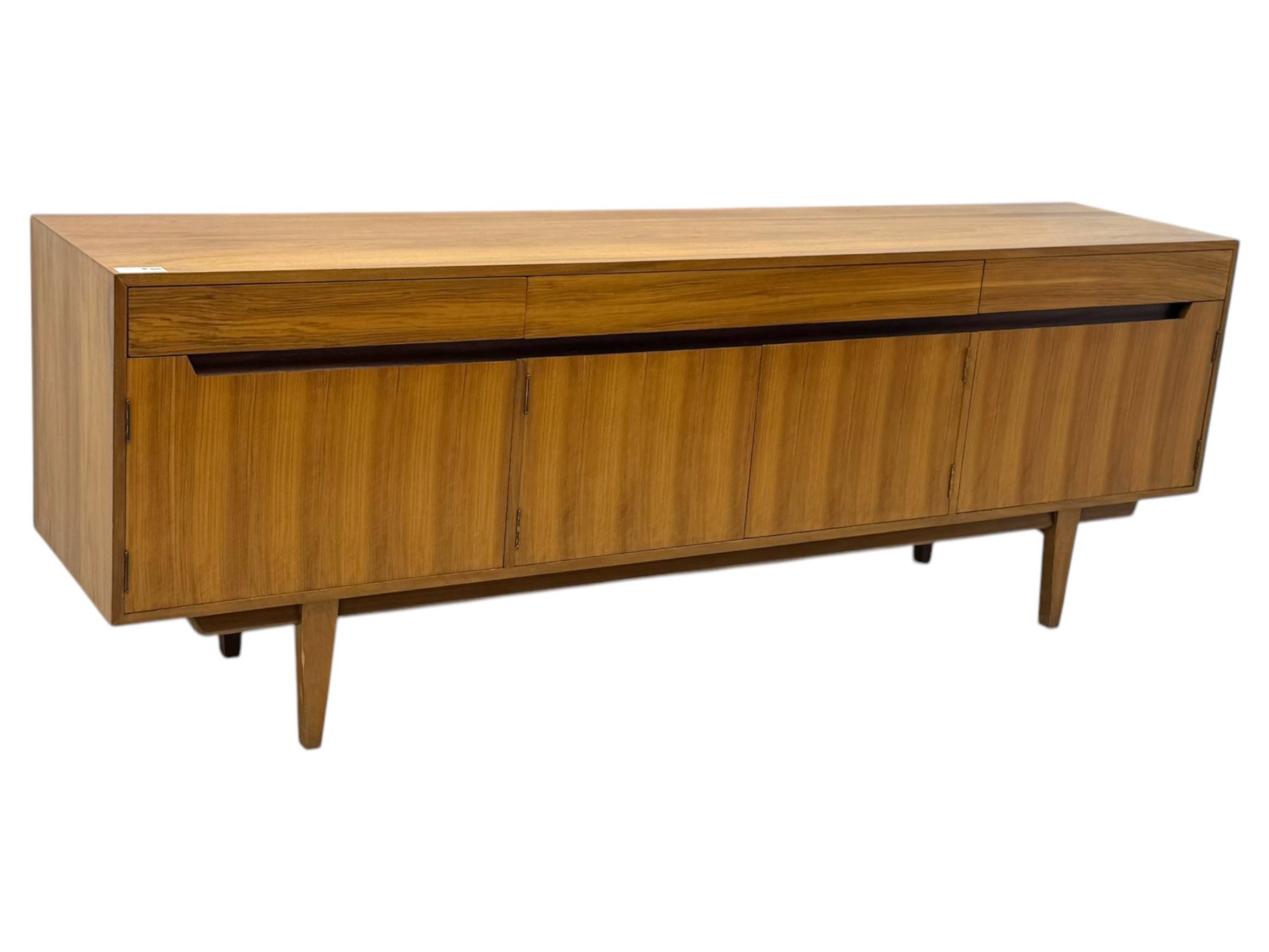 Younger - 1960s teak sideboard, three drawers over three cupboard, centre draw lined with baize with dividers, recessed handles with tapered feet