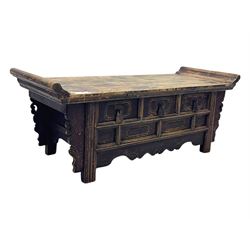 Mid-19th century elm low altar table, rectangular top with scrolled ends, fitted with three small drawers, pierced and scroll carved brackets, on square moulded supports 