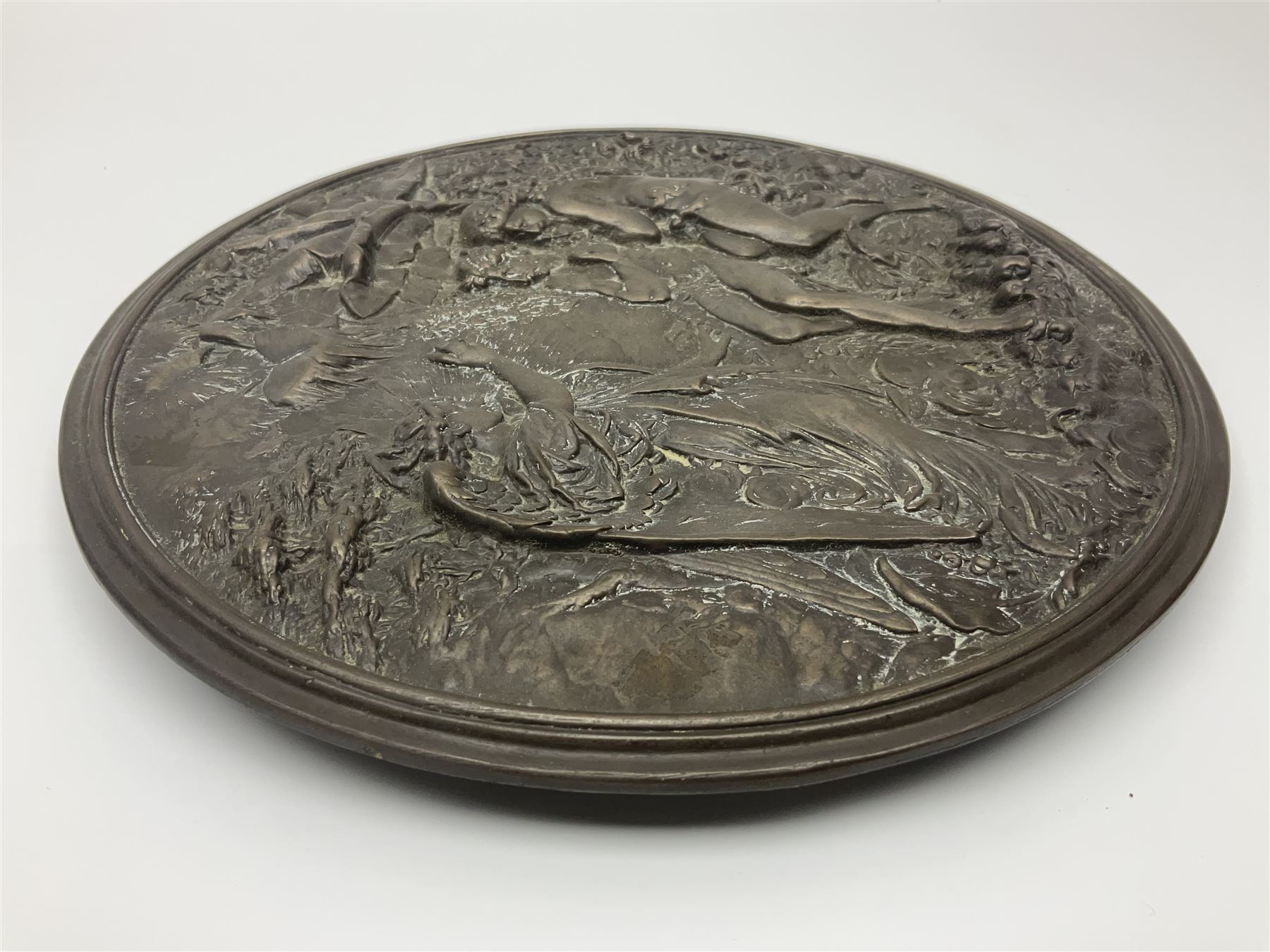 Late 19th century bronze plaque, of circular form, depicting the angel appearing to Adam and Eve in the garden of Eden in high relief, D25.5cm
