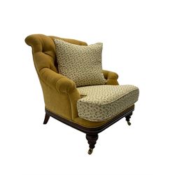 Victorian style armchair, upholstered in buttoned fabric with contrasting foliate pattern seat and scatter cushion, on turned front feet with castors