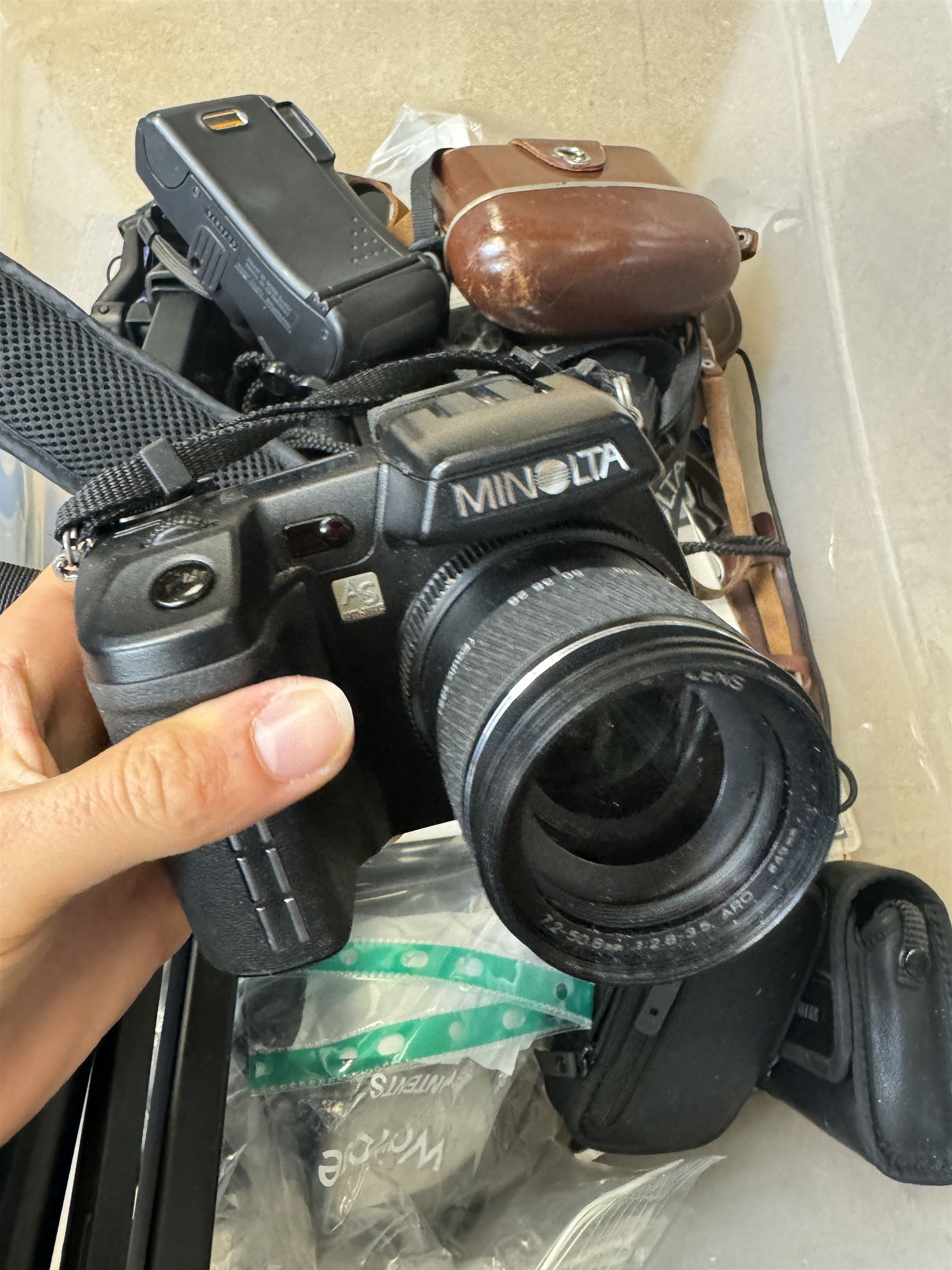 Collection of cameras and camera equipment, including Voigtlander Vitomatic I, Nikon Coolpix P340, Nikon Coolpix S9100, Olympus SP-510UZ, tripod, cases, etc