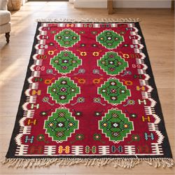 Persian Fars province crimson ground kilim rug, decorated with two rows of geometric emera...