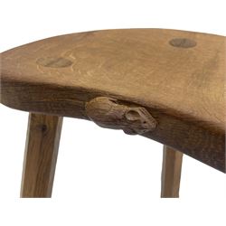 'Mouseman' oak three-legged stool, kidney shaped dished seat carved with mouse signature to edge, by Robert Thomas of Kilburn