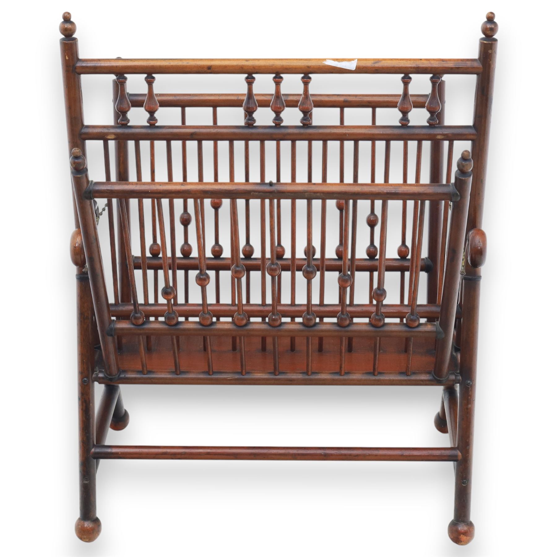Arts and Crafts mahogany magazine stand, in the manner of Christopher Dresser, folding magazine stand, rectangular divided slatted compartments with turned spindle galleries and ball finials, the sides forming an X-frame action, raised on turned supports united by stretchers