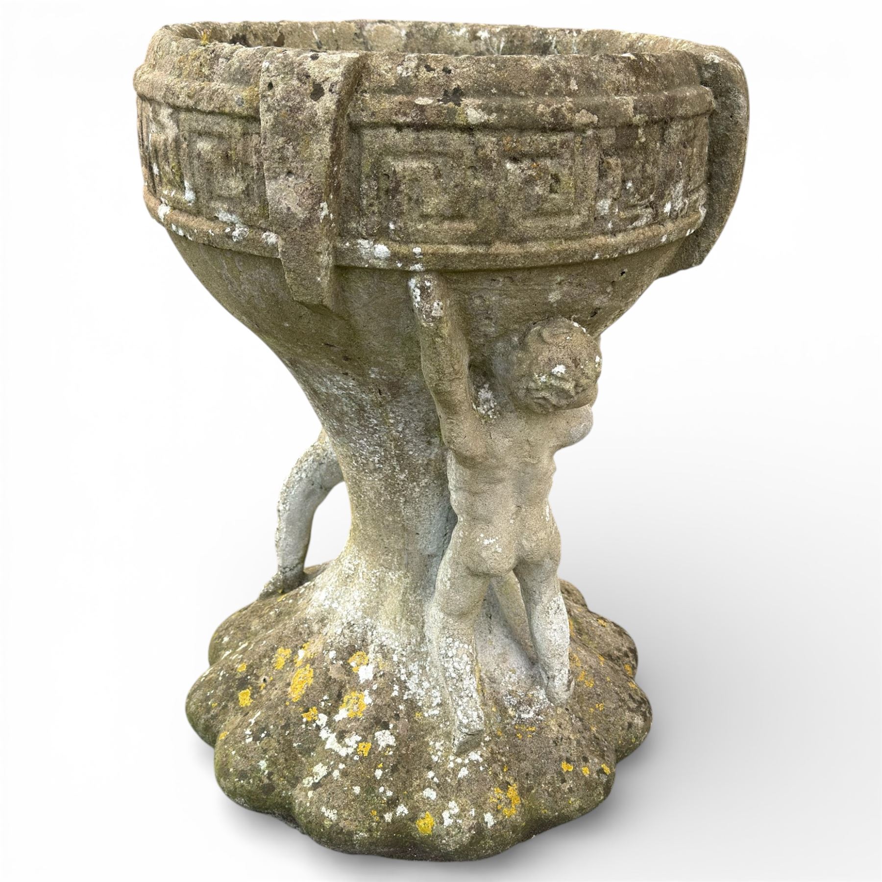 Cast stone urn with two figures supporting the bowl