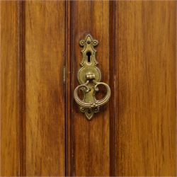 19th century mahogany triple wardrobe, moulded cornice above a central cupboard door enclosing shelves interior, flanked by full height panelled doors with clothes rails in each, the centre fitted with four graduated drawers with oval brass handles, on a moulded plinth base