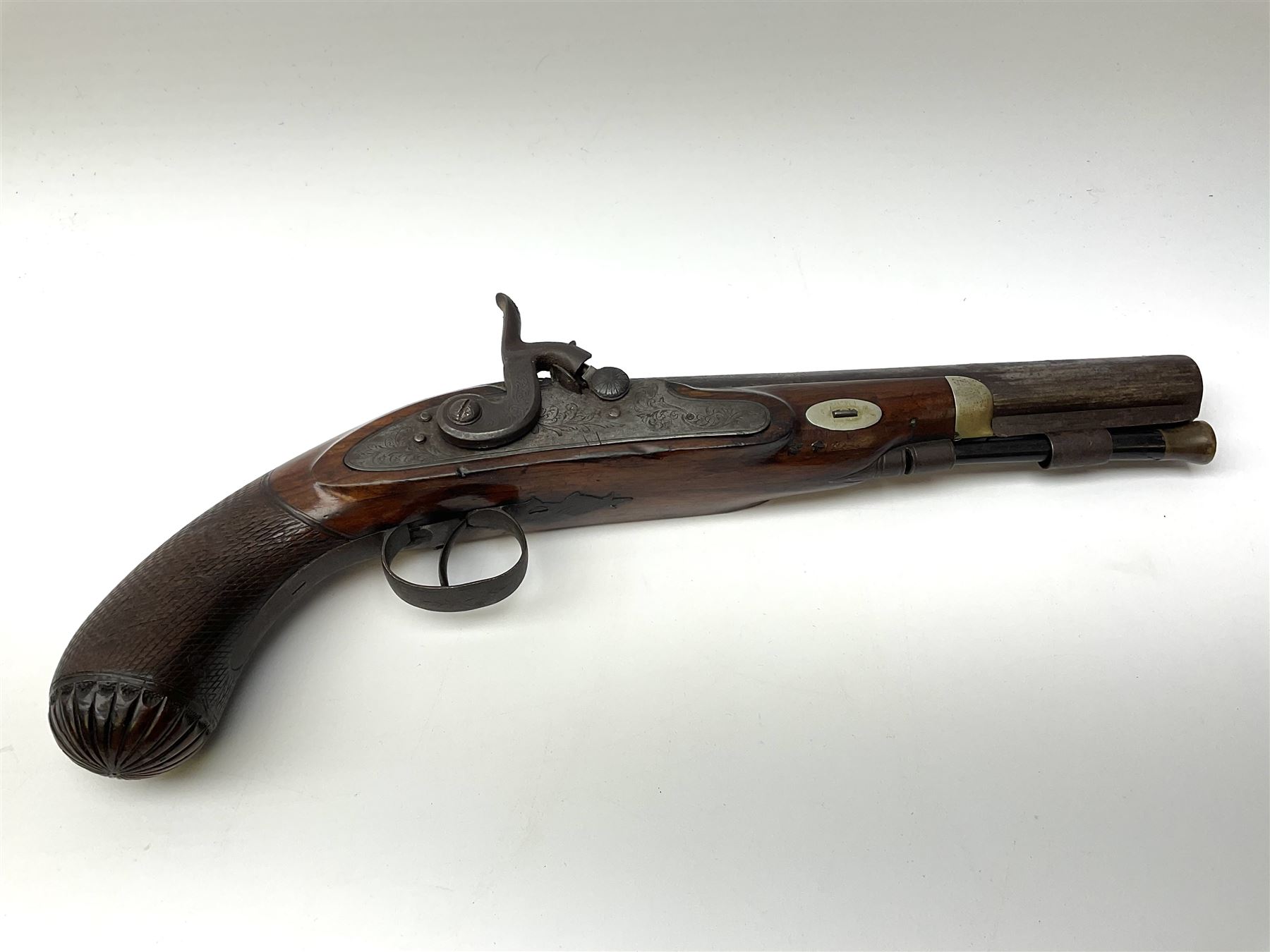 19th century flintlock converted to percussion cap target pistol, the 20.5cm barrel engraved with a sunburst motif to the top and ramrod under, foliate engraved lock-plate and trigger guard, silver plated fittings, walnut stock with chequered grip and melon fluted butt L35.5cm overall