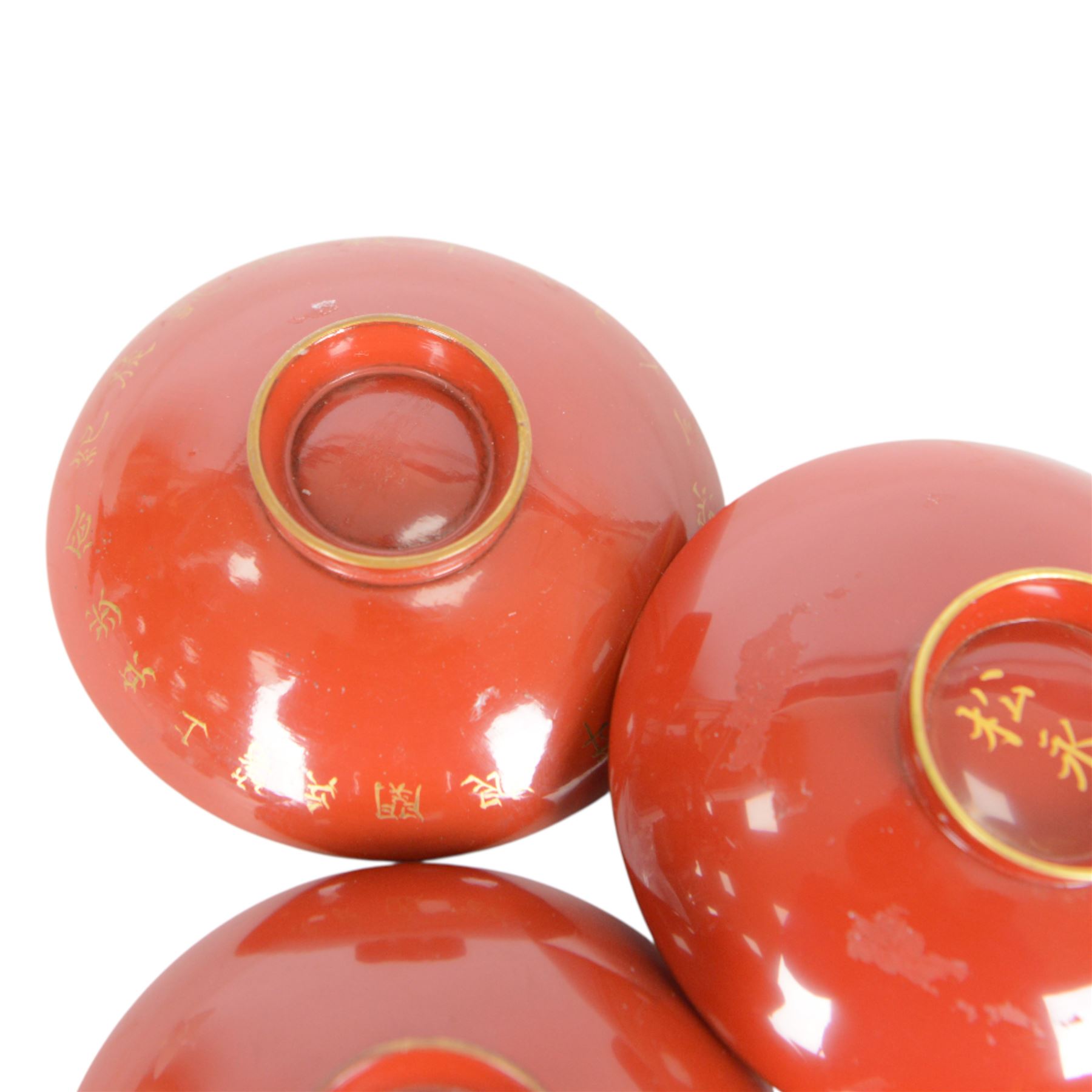 Five red lacquered saki bowls, together with five porcelain examples, red lacquered D9cm