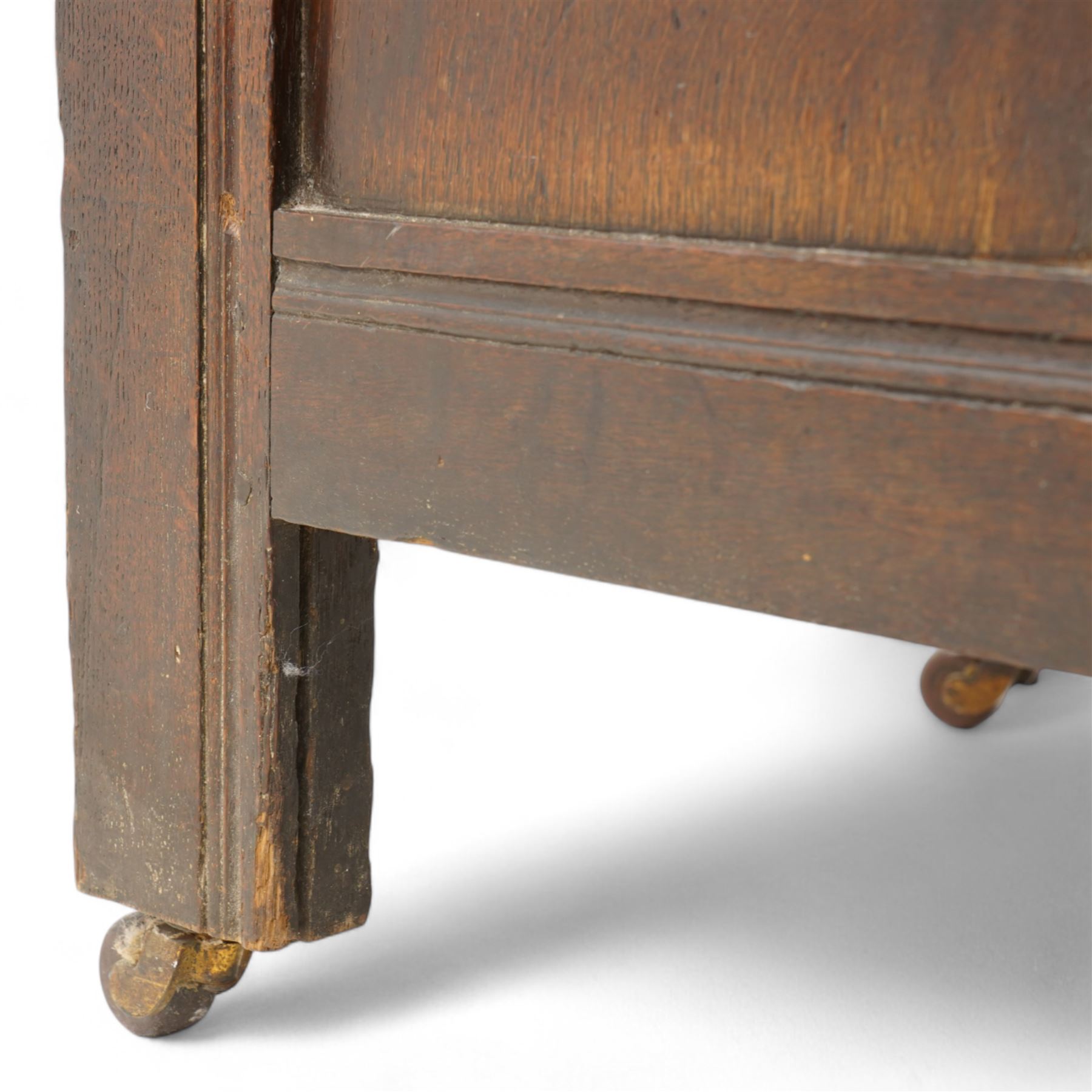 18th century oak blanket box, moulded rectangular hinged lid over lunette carved frieze rail and panelled front, moulded frame and panelled sides fitted with carrying handles, on stile supports