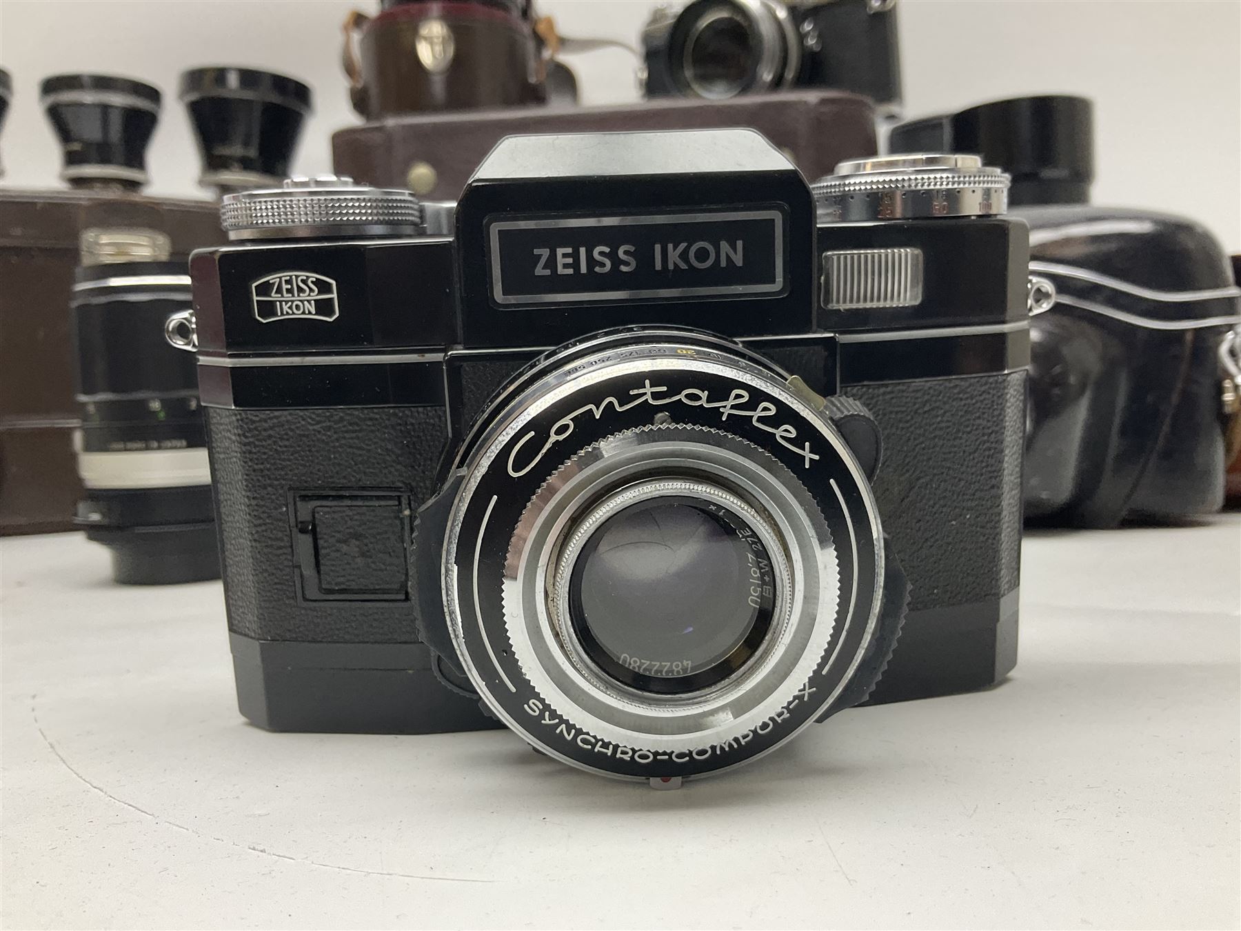 Four Zeiss Ikon camera bodies, to include, Contaflex Super B camera body, serial no. B31591, with 'Carl Zeiss Tessar 2.8/50 lens, serial no.3425553, Contaflex Super BC camera body, serial no. P81728, with 'Carl Zeiss Tessar 2.8/50' lens, serial no 4822280, etc, together with three cased lenses; 'Carl Zeiss Pro-Tessar 1:4 f=115mm' lens, serial no 3734740, 'Carl Zeiss Pr-Tessar 1:3.2 f=85mm' lens, serial no. 3647764 and 'Carl Zeiss Pr-Tessar 1:3.2 f=35mm' lens, and other Zeiss Ikon equipment 