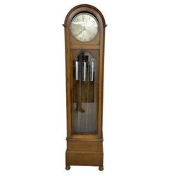 German - 1930s 8-day chiming longcase clock in an oak case, with a break arch top and fully glazed door, plinth raised on bun feet, circular silvered dial with Arabic numerals and pierced steel hands, three train weight/chain driven movement sounding the quarters and hours on 12 gong rods, with chrome cased weights and conforming pendulum. 