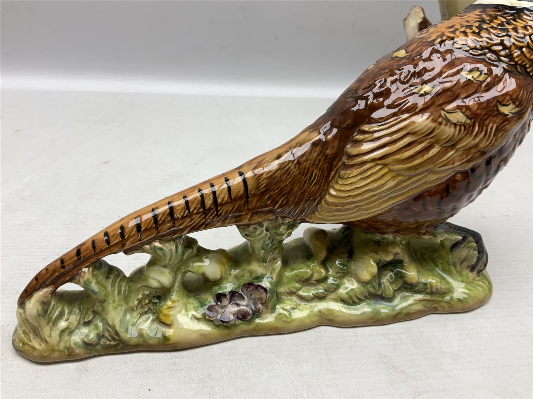 Three Beswick figures of birds, comprising pheasant no 1225, magpie no 2305 and woodpecker 1218, all with impressed marks beneath, tallest H22cm