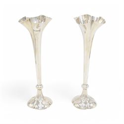 Pair of Edwardian silver mounted vases, of trumpet form with quatrefoil beaded rims, upon ...