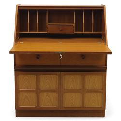 Parker Knoll - teak bureau, sloped fall front enclosing fitted interior, over two short drawers and two panelled cupboard doors