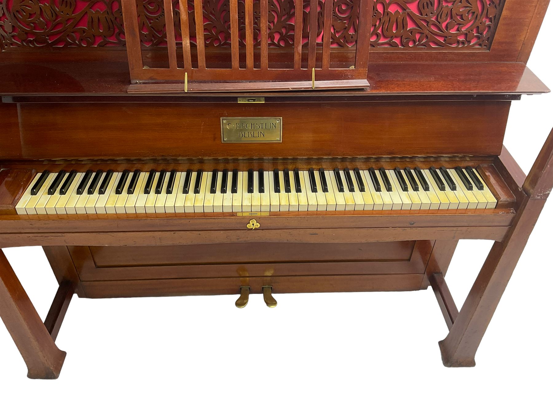 Carl Bechstein - late 19th century German overstrung upright piano, in a model 4 Arts and Crafts case designed by Walter Cave, with a lattice music desk and fretted silk backed front panel, brass hinged case lid and key fall with square tapered candle holders and circular sconces, iron frame, serial number 52187 (1899-1900), with an under damper action, 85 ebony and ivory keys, sustain and una corda pedals, original action, stringing, dampers, and action return straps, registered case number 328639, USA patent 24805.

This item has been registered for sale under Section 10 of the APHA Ivory Act