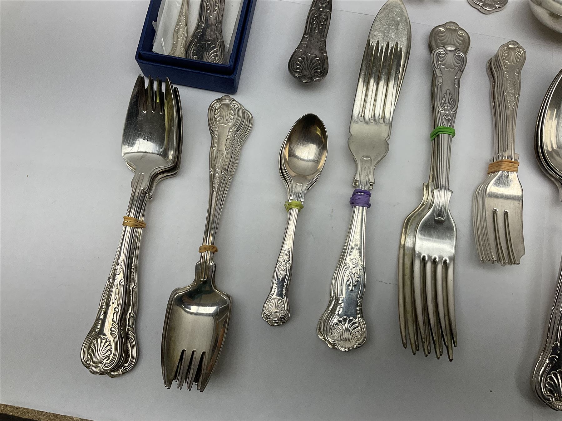 Silver Kings pattern knife, hallmarked Walker & Hall, together with a quantity of silver plated Kings pattern cutlery, including items by Osbourne's and United Cutlers, comprising table knives, table forks, table spoons, serving forks, ladle, berry spoons, teaspoons, dessert forks, cake slice, etc