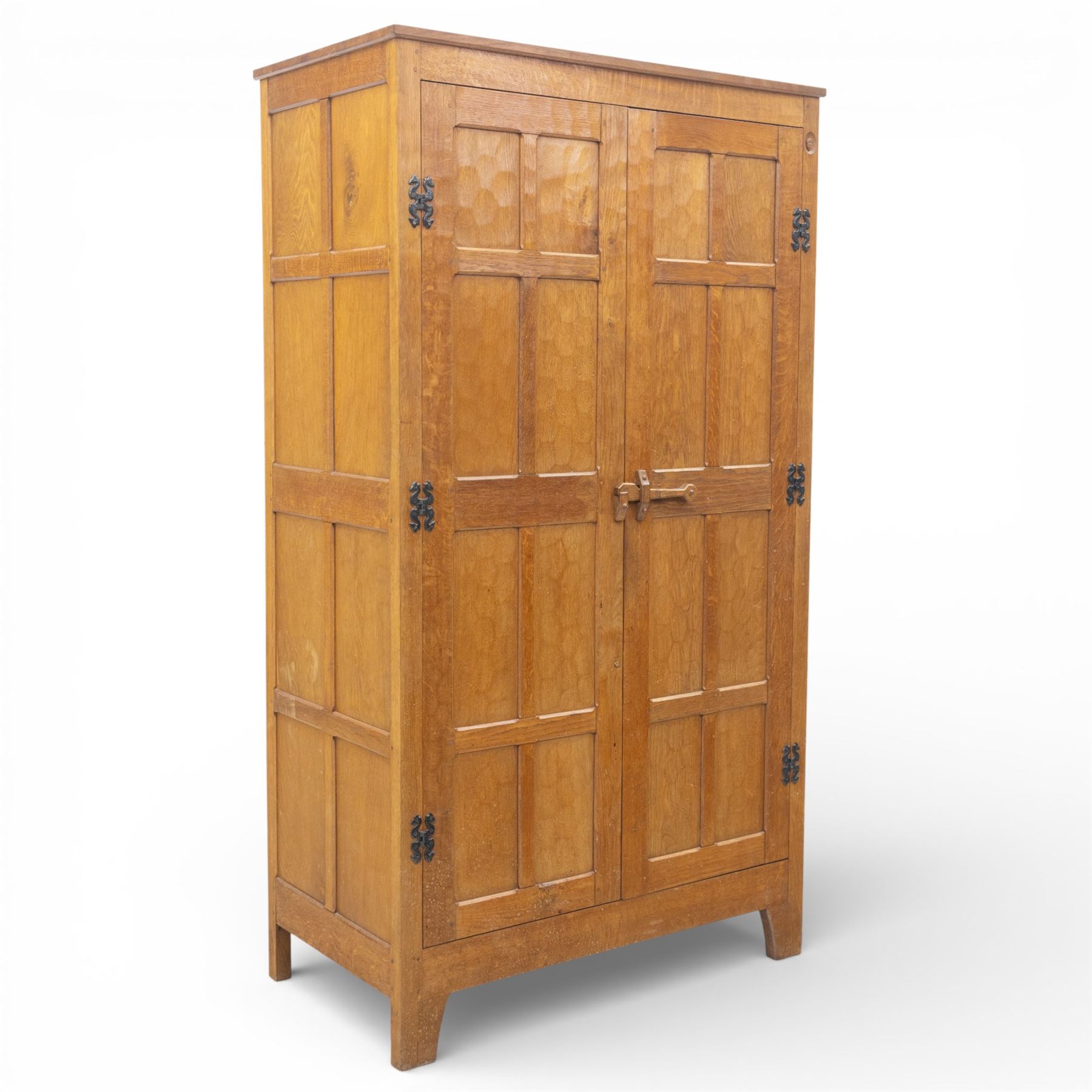 Acornman - oak adzed panelled double wardrobe, with wrought iron hinges and carved oak latch revealing a single clothes rail, with signature carved acorn to top right, by the workshop of Alan Grainger, Brandsby
