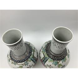 Pair of Chinese Republic porcelain vases, each painted in Famille Rose enamels with pairs of pigeons amidst peony, rock, flowering plants and leafy branches, possibly Qianlong seal beneath, H22cm 