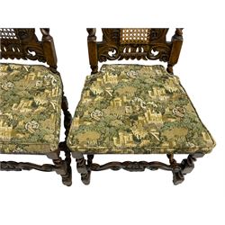 Set six 19th century oak Carolean style dining chairs, the cresting rail with open crown flanked by putto, spiral turned uprights with pineapple finials, canework seat and back, the seat rails carved with foliage, spiral turned supports joined by s-scroll and open crown carved front rail, decorated with flower heads, each with upholstered seat pad