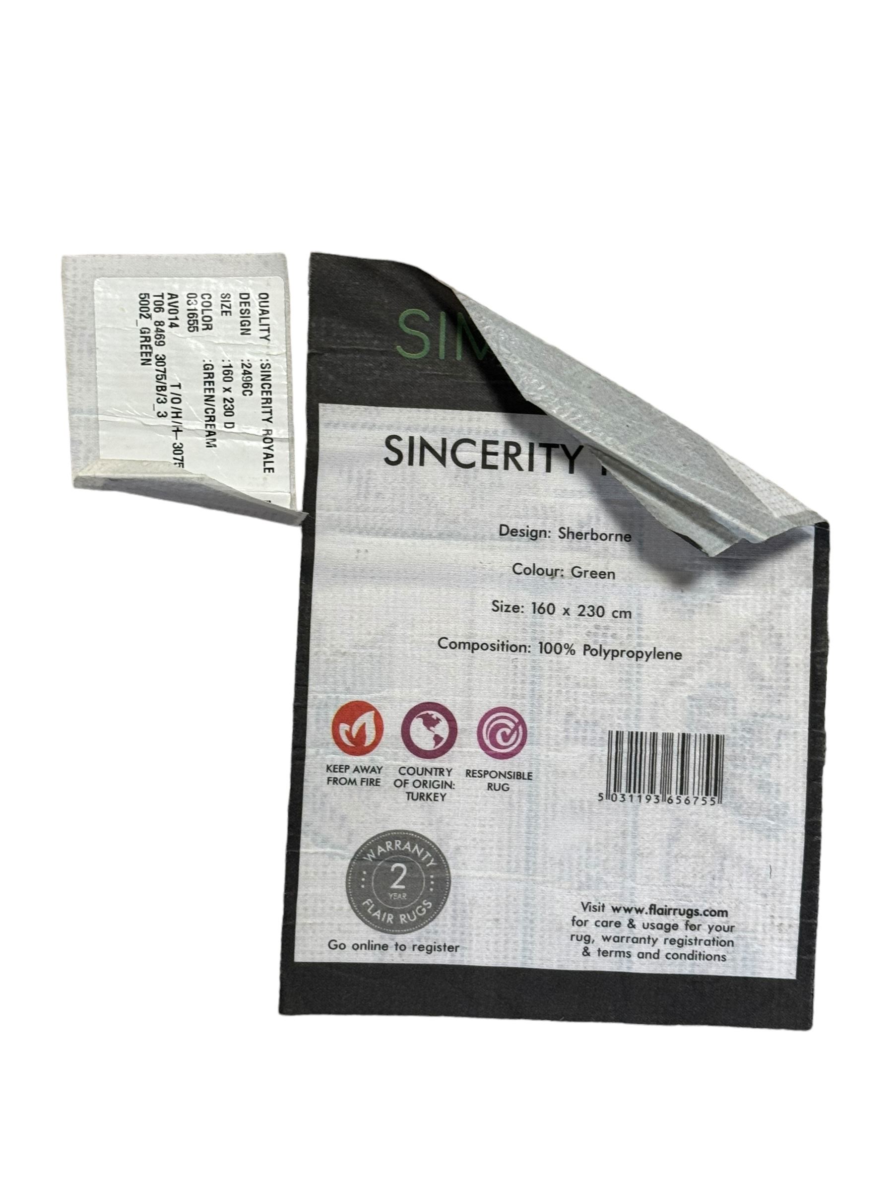 Turkish Sincerity Royale green ground rug, the field decorated with a central floral medallion surrounded by scrolling floral motifs in shades of cream, beige, and burgundy, spandrels filled with matching floral designs, the border featuring a series of floral patterns on a cream ground, finished with green edges