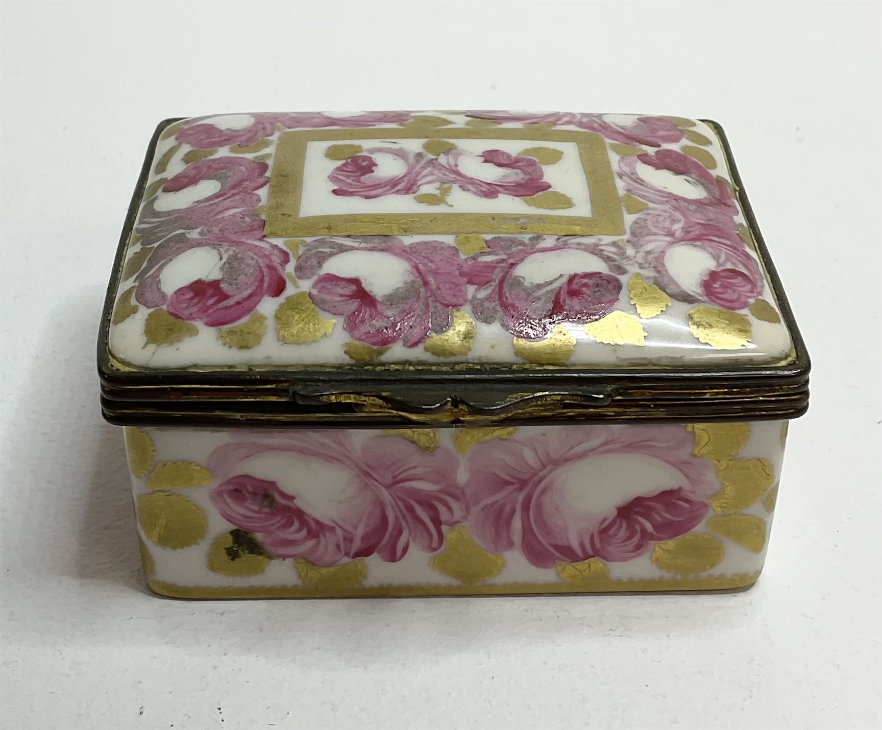 Early 19th century Swansea box of rectangular form, densely decorated with painted pink cabbage roses and gilt foliage upon plain ground, the hinged lid opening to reveal interior painted with two further roses upon plain ground, marked Swansea. in gilded lettering beneath, W7cm H3.5cm D5.5cm