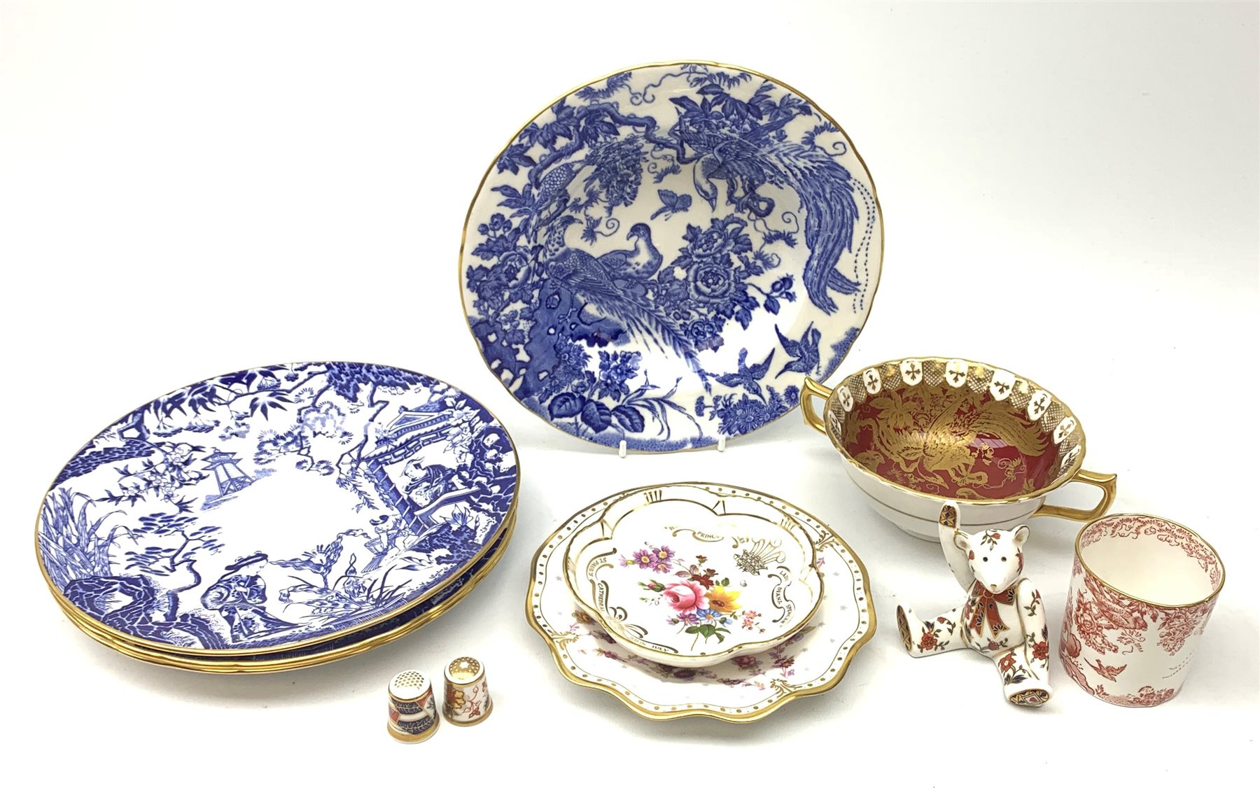 A selection of assorted Crown Derby, comprising three Mikado pattern dessert plates, D21.5cm, a Blue Aves pattern dish, a small Red Aves beaker, a Gold and Red Aves twin handled soup bowl with heraldic border, a small Royal Antoinette pattern plate, small commemorative dish, and a paperweight modelled in the form of a teddy bear (lacking stopper). 