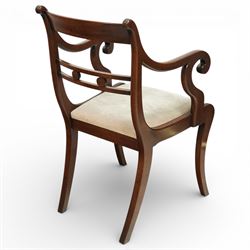 Arthur Brett & Sons - Regency design mahogany extending dining table and eight chairs, the oval top with rounded ends and two extension leaves, raised on twin pedestal supports with swept legs terminating in brass caps and castors, accompanied by a set of eight chairs comprising six single chairs and a pair of carvers, the chairs with curved backs and horizontal splat rails, upholstered seats, sabre legs and scrolling arms to the carvers
(Extends to 252cm)
(Chairs H 86cm, W 52cm)